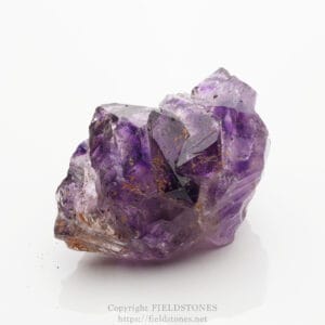 Purple amethyst crystal cluster on a white background, showing faceted prisms and natural inclusions.