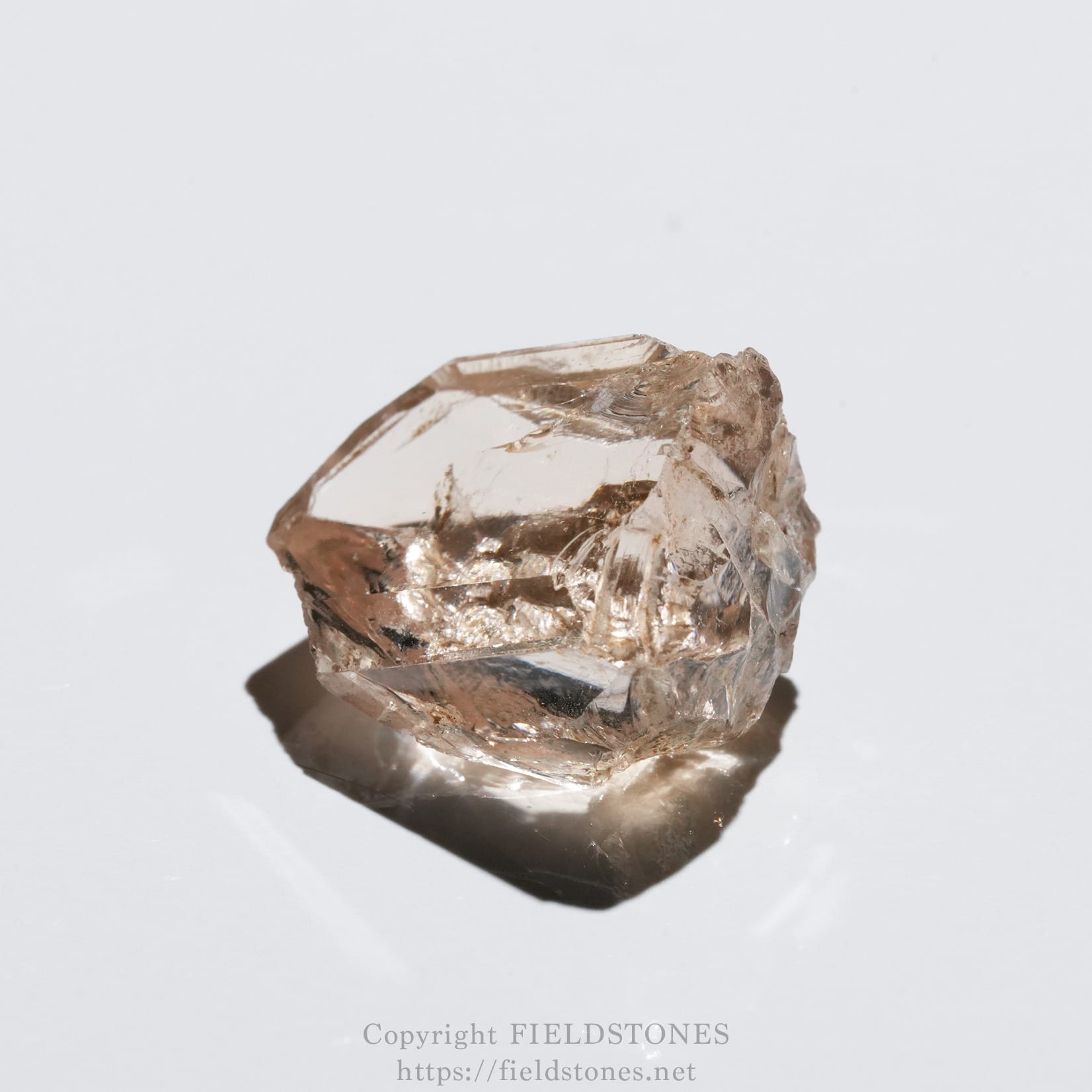 6578-12 - FieldStones Rough pink quartz crystal with faceted surfaces on a white background.