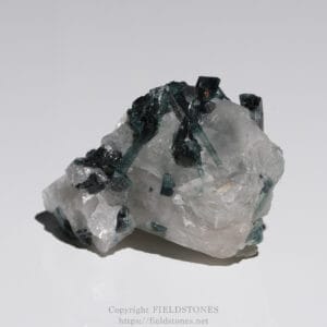 Green fluorite crystals forming a cluster on a white quartz rock.