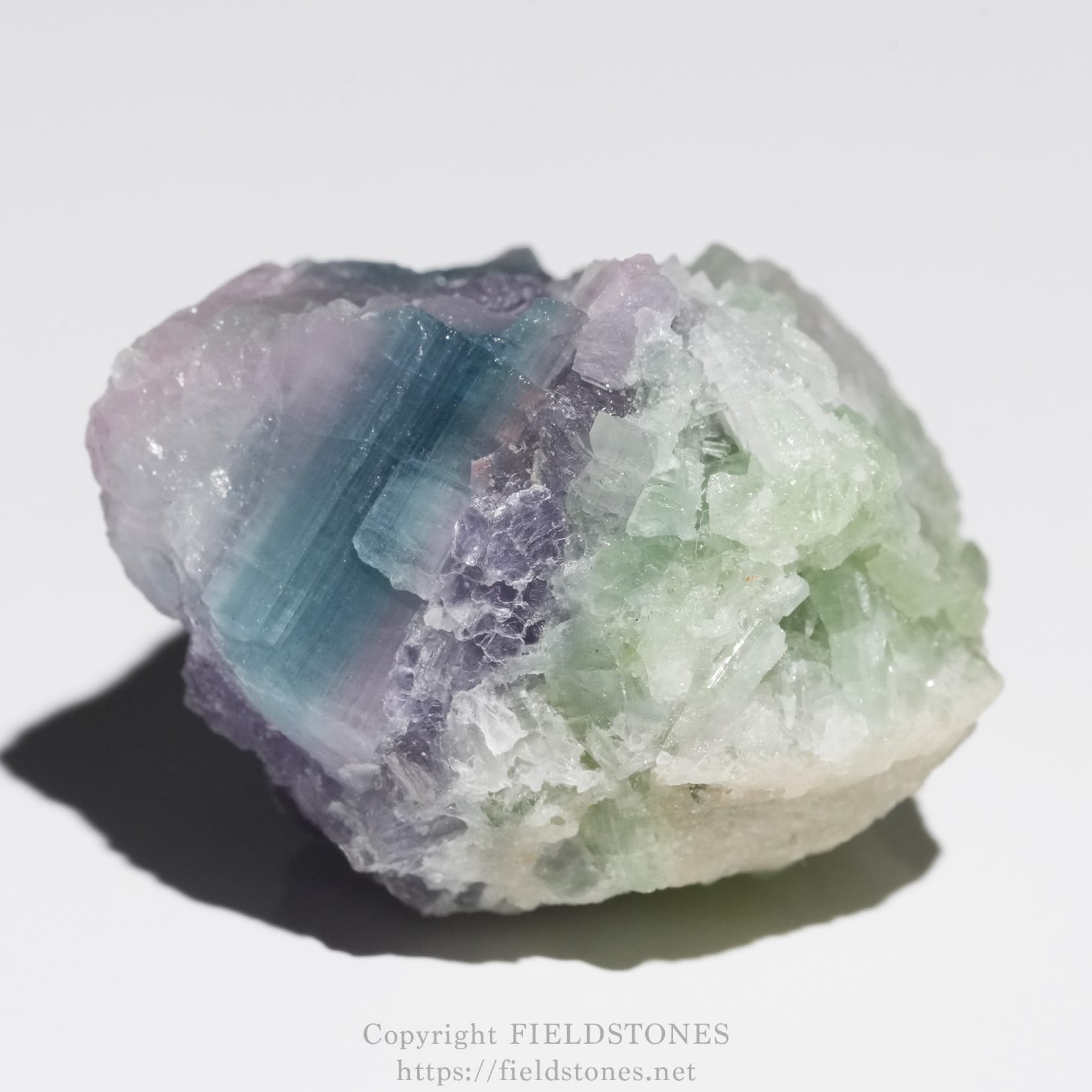 6645-1 - FieldStones Pastel-colored crystal cluster with blue, purple, and green hues on a rough white base