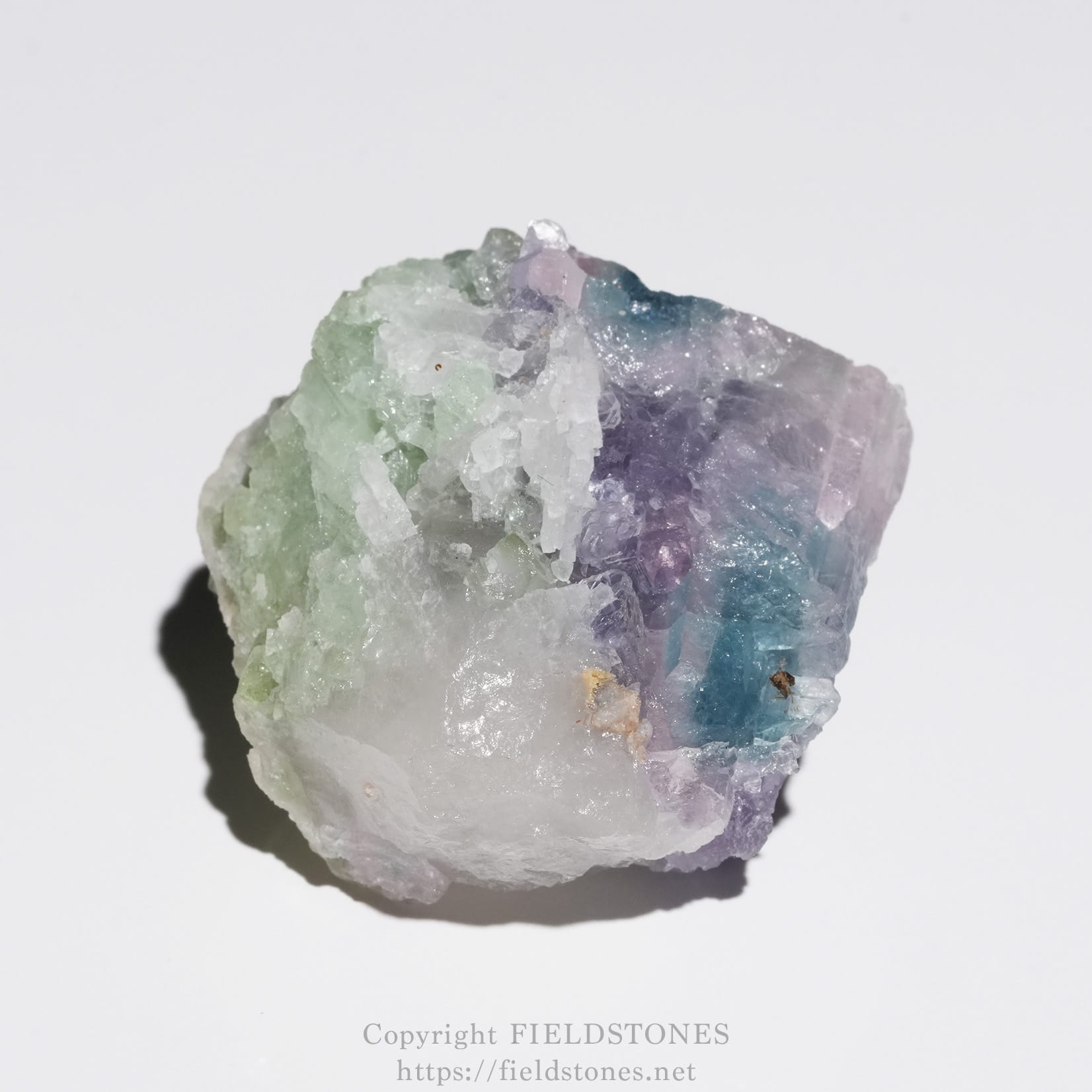 6645-7 - FieldStones Cluster of pastel-colored crystals in green, purple, and blue hues on a white rock matrix.
