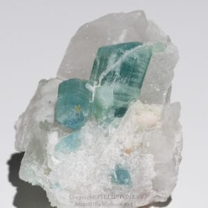 Greenish-blue fluorite crystals embedded in white quartz matrix, showing rectangular tabular habit and glossy faces
