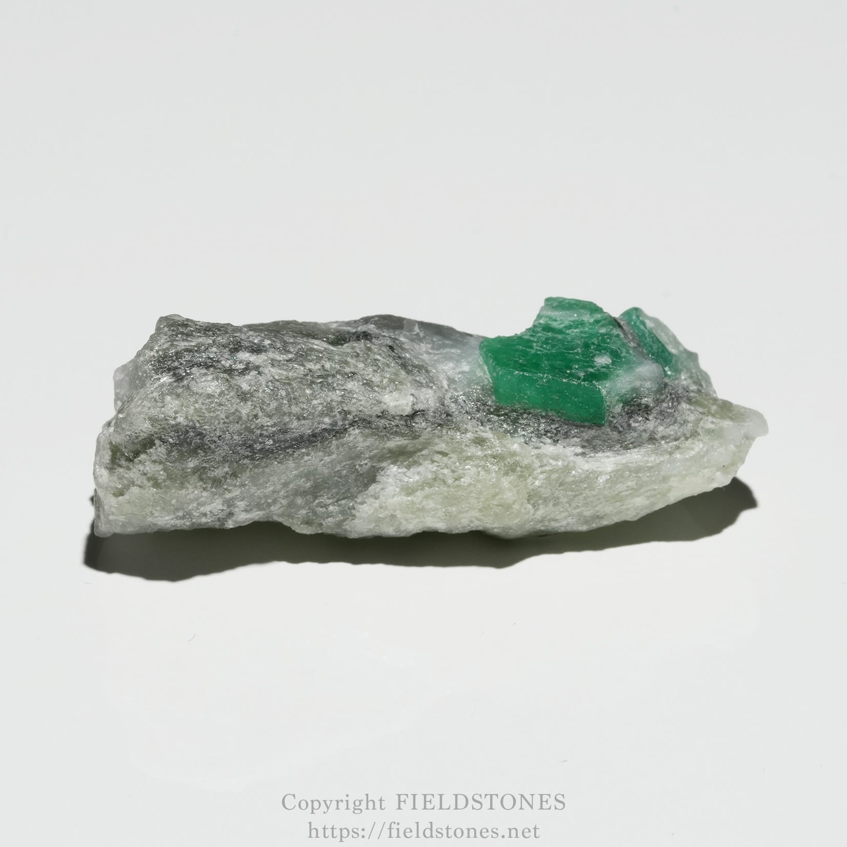 6696-5 - FieldStones Rough gray rock with small, bright green crystals embedded on top.
