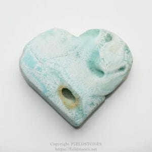 Turquoise blue soap bar with a hollow pocket and textured surface on a white background