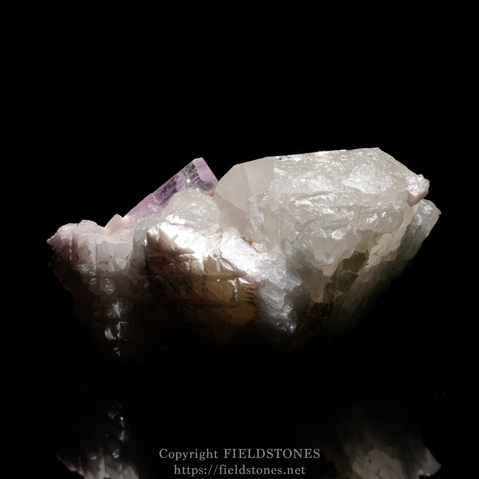 6725-6 - FieldStones Cluster of clear quartz crystals with pale pink-purple tips against a black background.