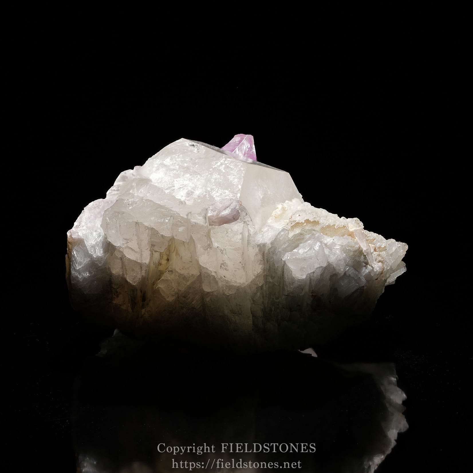 6725-7 - FieldStones White quartz crystal cluster with a small pink crystal perched on its peak against a black background.