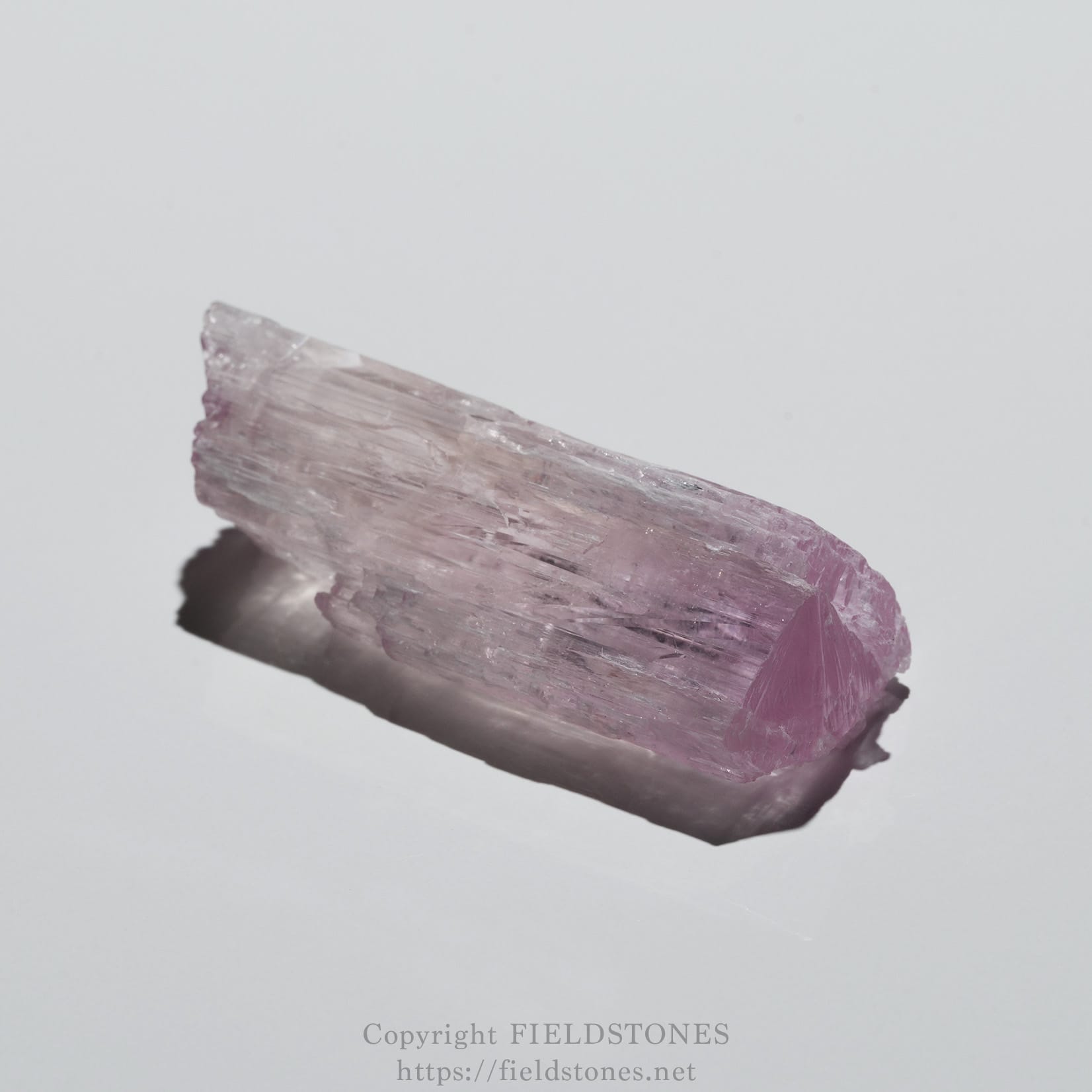 6726-3 - FieldStones Pink kunzite crystal fragment on a pale background, showing layered translucent facets.