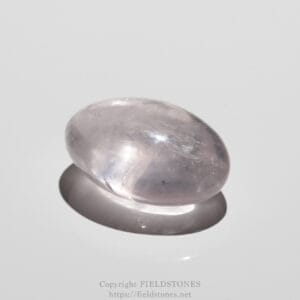 Polished pale pink tumbled stone resting on a reflective white surface.