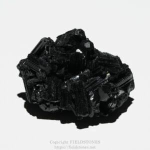 Shiny black crystalline mineral cluster on a white background.
