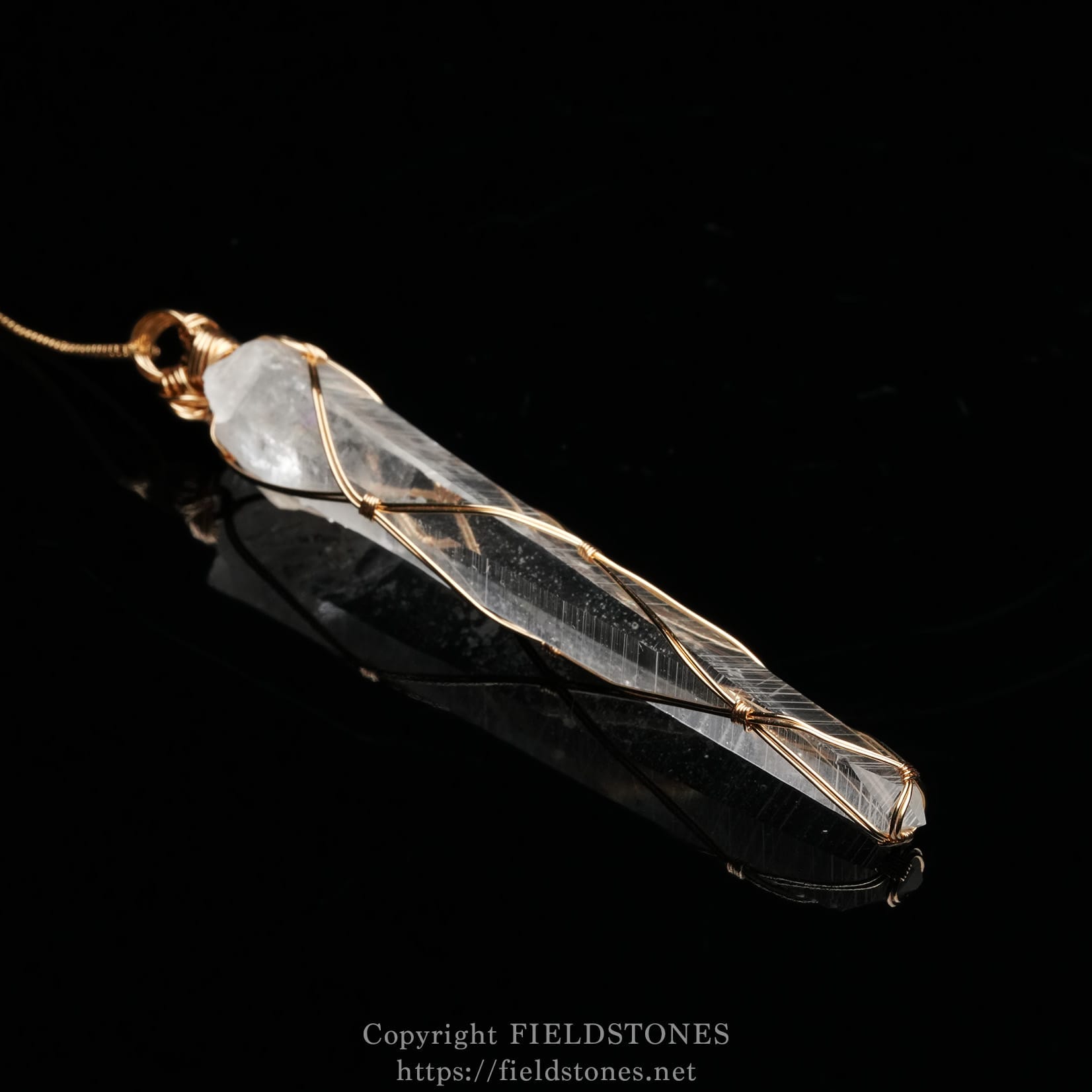 6751-4 - FieldStones Copper-wrapped crystal pendant on a black background